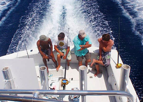 A photograph of a Panoply Sport Fishing and Charters boat heading out from Providenciales (Provo), Turks and Caicos Islands