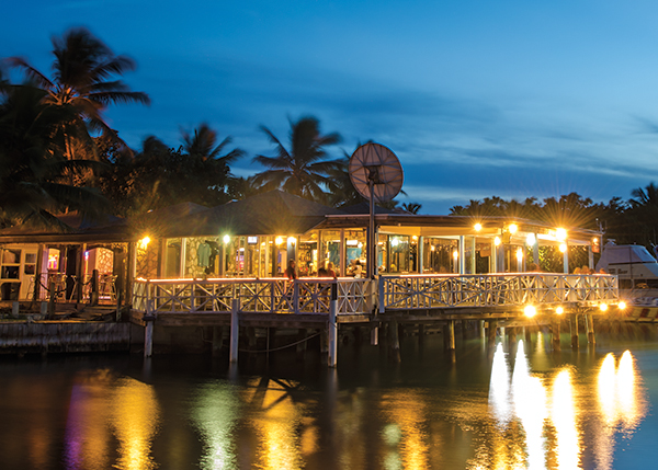 A photograph of The Sharkbite Bar & Grill sits over the water at Turtle Cove Marina, Turtle Cove, Providenciales (Provo), Turks and Caicos Islands.