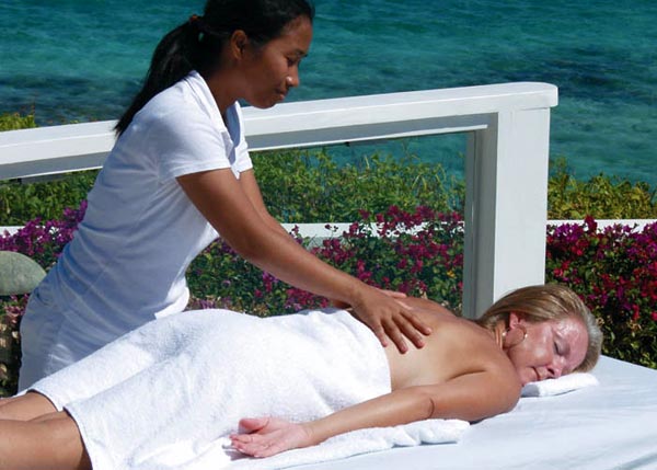 A photograph of a lady having a Spa Tropique massage on Providenciales (Provo), Turks and Caicos Islands